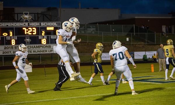 Two Summit High football players celebrate on field
